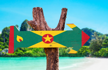 Grenada Flag wooden sign with beach background - obrazy, fototapety, plakaty