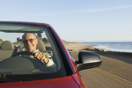 Senior German man driving convertible car