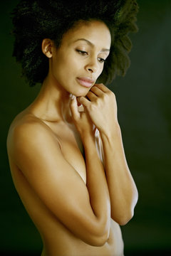 Nude mixed race woman covering her body