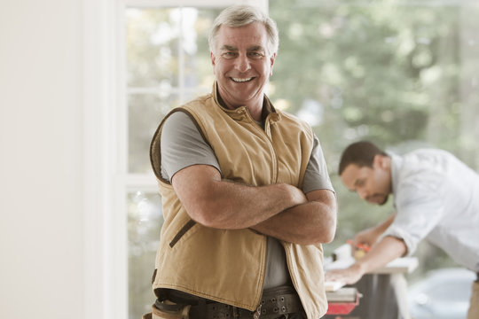 Caucasian carpenter standing with arms crossed