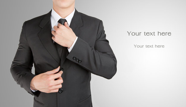 Well dressed businessman looklike smart adjusting  his neck tie