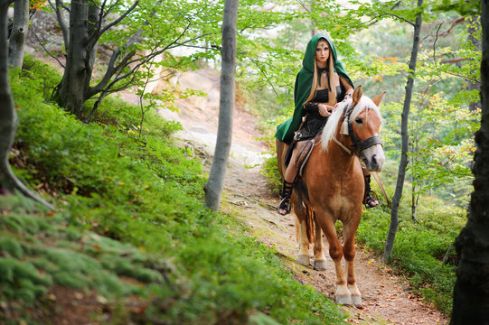 sexy woman warrior on horseback in the woods