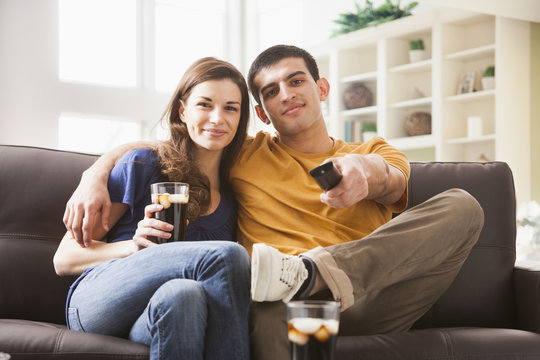 Couple watching television on sofa