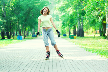 Roller skating sporty girl in park rollerblading on inline skate