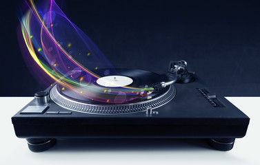 Turntable playing vinyl with glowing abstract lines