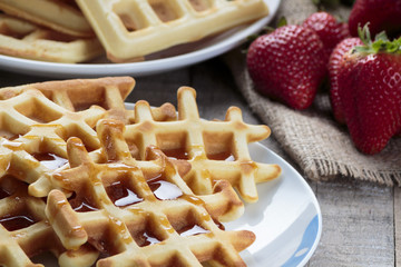 Waffles covered with maple syrup