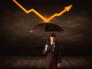 Businessman standing with umbrella keeping orange arrow