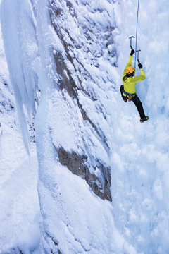 Caucasian climber scaling glacier