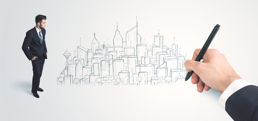 Businessman looking at hand drawn city on wall