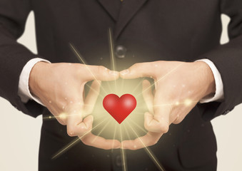 Hands creating a form with shining heart