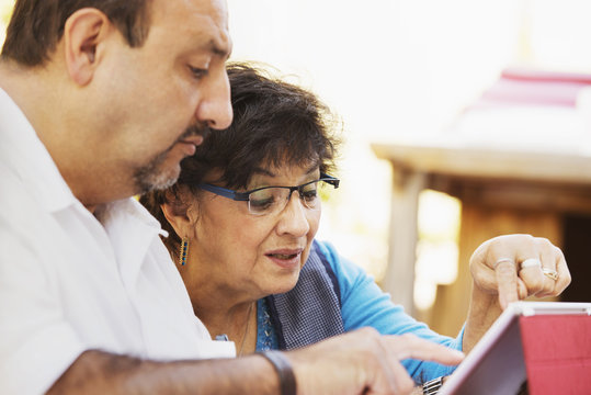 Hispanic mother and son reading together