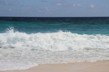 Wave breaking on pink beach