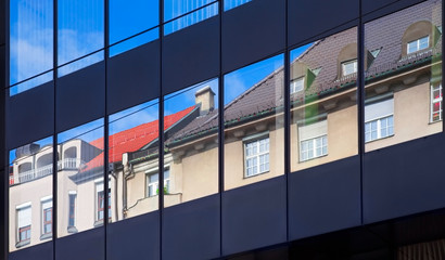 Old building architecture reflected in modern building