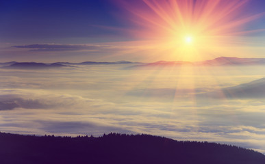 Beautiful foggy landscape in the mountains. Sunrise.