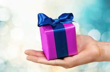 Gift. Small gift box in woman hand - christmas present, isolated