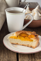 Shortcrust peach pie and cup of tea