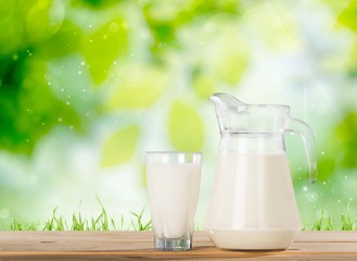 Milk. Milk on table and sunny trees