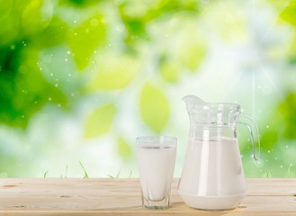 Milk. Milk on table and sunny trees