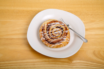 Cinnamon Roll with Fork on Plate