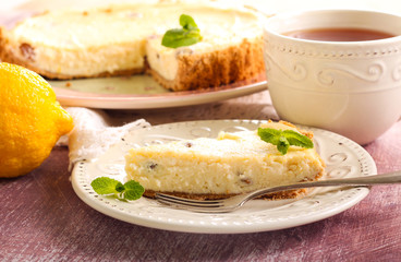 Lemon cheesecake with raisin and cup of tea