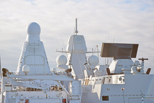 Two White Naval Ships With Radar And Other Communications.