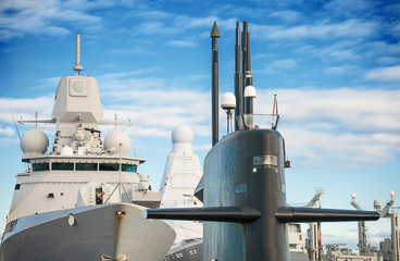 Naval fleet. Submarine and warships with guns.