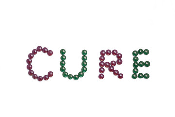 Cure written with purple and green pills