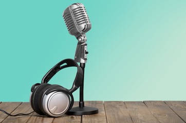 Aquamarine. Retro microphone and headphones on table
