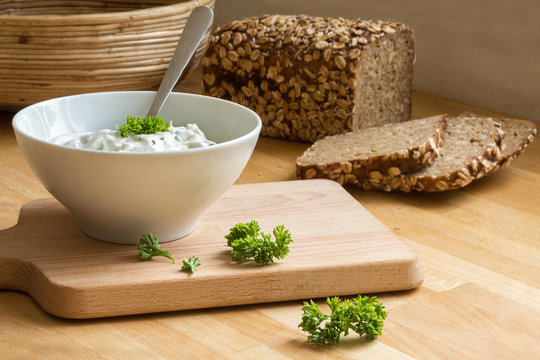 Curd Cheese Dip With Herbs In A Bowl And Rustic Bread In The Bac