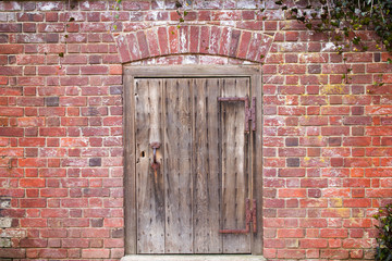Antique wooden door on brick wall.