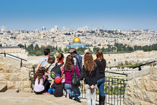 Tourists are looking at the beautiful view of Jerusalem