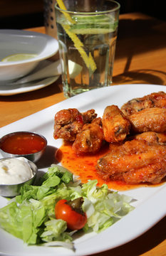Bbq chicken wings with dips and salad