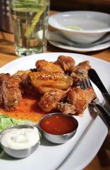 Bbq chicken wings with dips and salad