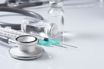 Medical equipment : stethoscope ampules and syringe on white ba