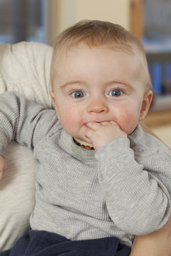 Caucasian baby chewing fingers