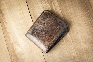 brown leather wallet on wood board background