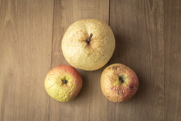sear apple and chinese pear on wood background