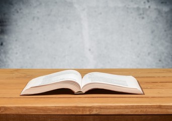 Book. Open book on wood table over grunge background