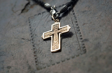 golden cross on old book
