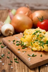 Vertical photo of scrambled eggs with chopped chive