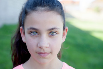 Portrait of a beautiful preteen girl with blue eyes