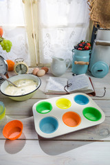 Baking tasty cupcakes with berry fruits