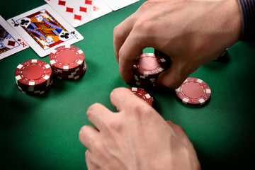 dealer collects red poker chips