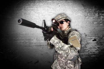 Fototapeta premium soldier holding his assault rifle