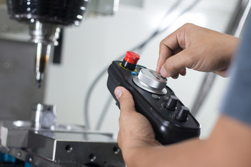 worker working with cnc milling machine at workshop.