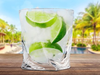Gin. Cocktail with ice and lime slice isolated on white