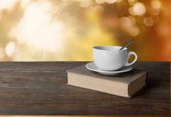 Tea. Cup of coffee and book on wooden table