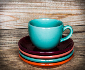 set of colorful cups and dishes and dessert