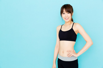 Fototapeta na wymiar sporty asian woman on blue background
