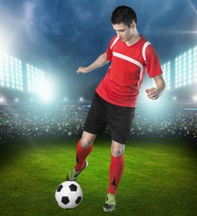 Soccer. Professional soccer player kicking ball. Isolated on